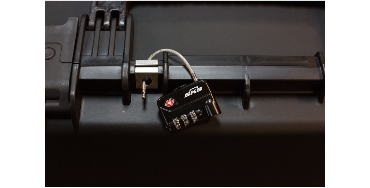 TSA Approved Combination Cable Padlock securing a hard case latch, showcasing its use for bow, gun, or single-lid travel cases.