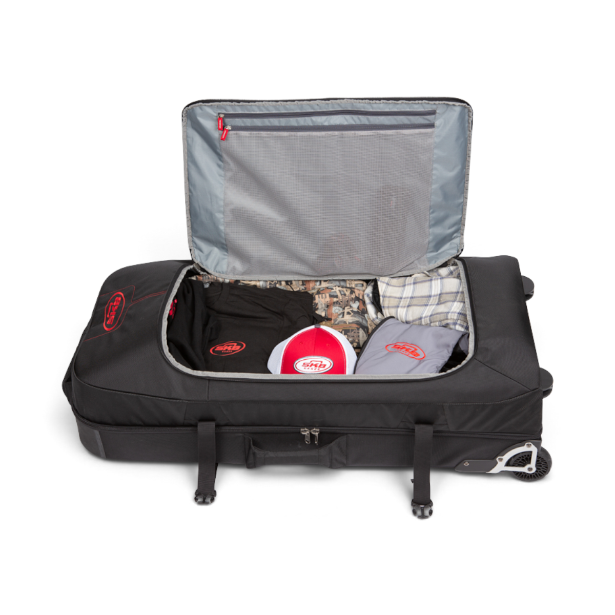SKB Cases Bow Traveler luggage open with packed clothing and accessories, featuring a rigid padded interior.