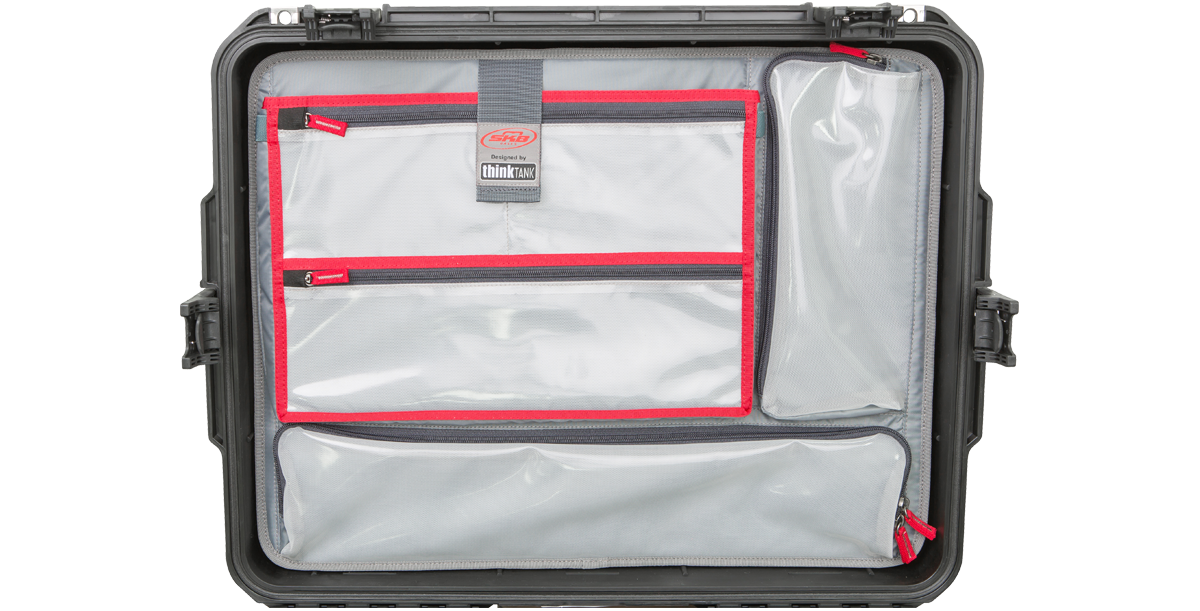 iSeries 2217 Lid Organizer - SKB iSeries lid organizer securely mounted inside case lid with clear mesh pockets and red zippers for compact storage.