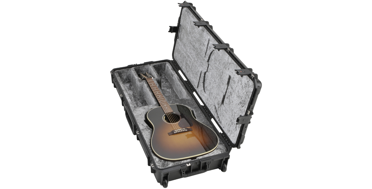 Waterproof iSeries Guitar Case angled view with acoustic guitar, featuring molded interior and reinforced latches for secure transport.