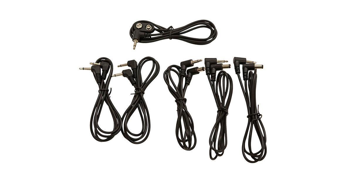 Unboxed 9V Pedalboard Adapter Cable Kit showing five black adapter cables with various plug types for guitar pedalboards.