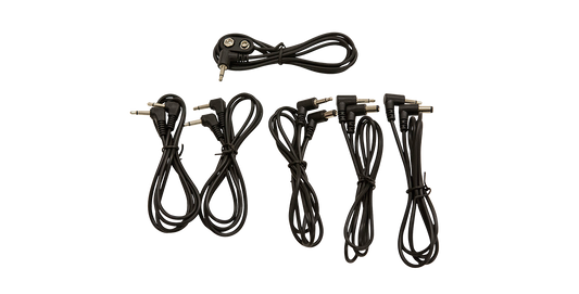 Unboxed 9V Pedalboard Adapter Cable Kit showing five black adapter cables with various plug types for guitar pedalboards.