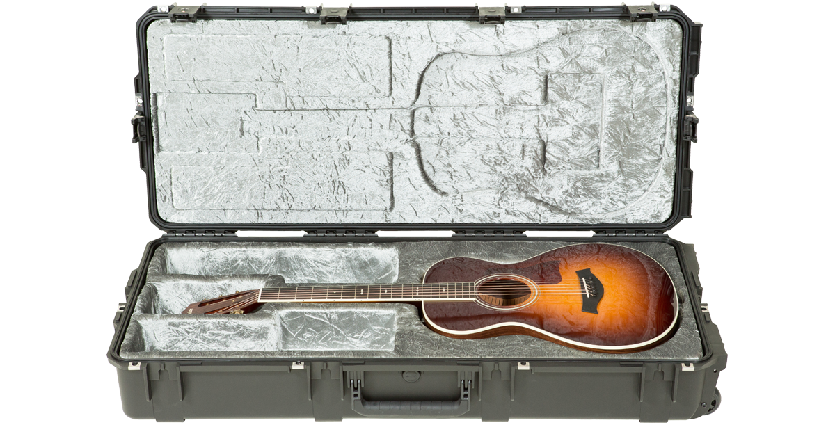 Waterproof Guitar Case - iSeries Case with plush silver interior securely holding an acoustic guitar; features TSA locks and rugged design.