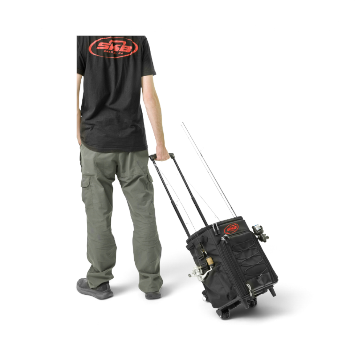 Person pulling a black SKB Cases Tak-Pak fishing tackle backpack with wheels and a retractable handle