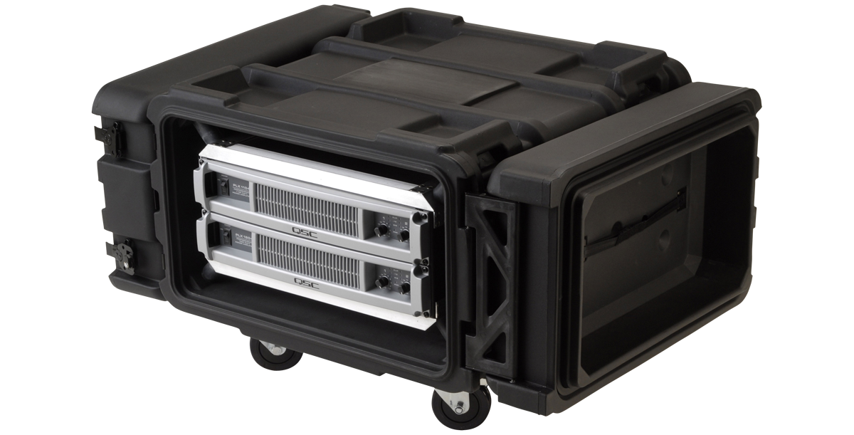 24 inch deep shock rack with dual QSC amplifiers, shown from rear angle with rugged wheels and MIL-SPEC sealing for mobile deployment.