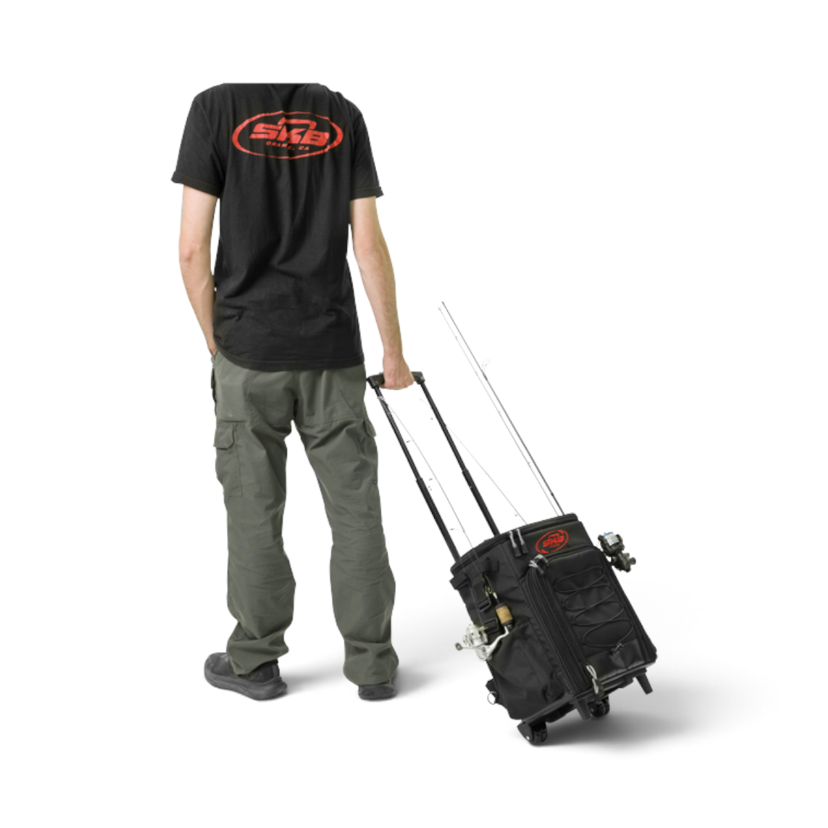 Person pulling a black SKB Cases Tak-Pak fishing backpack with wheels and fishing rods attached