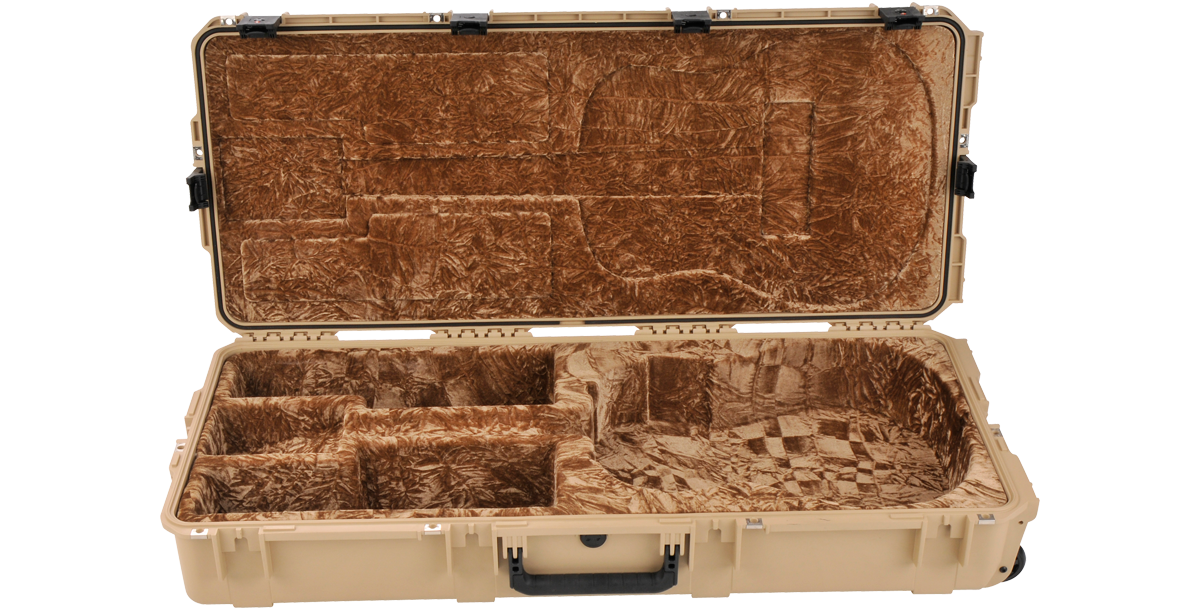 Empty SKB waterproof acoustic guitar case in tan, showing custom plush interior compartments for dreadnought guitar and accessories.
