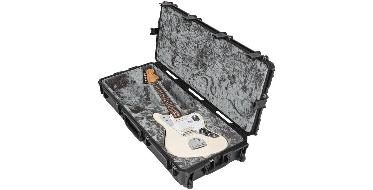 White Jaguar guitar in rugged waterproof case with TSA locks, ideal for travel and storage with molded interior for secure fit.