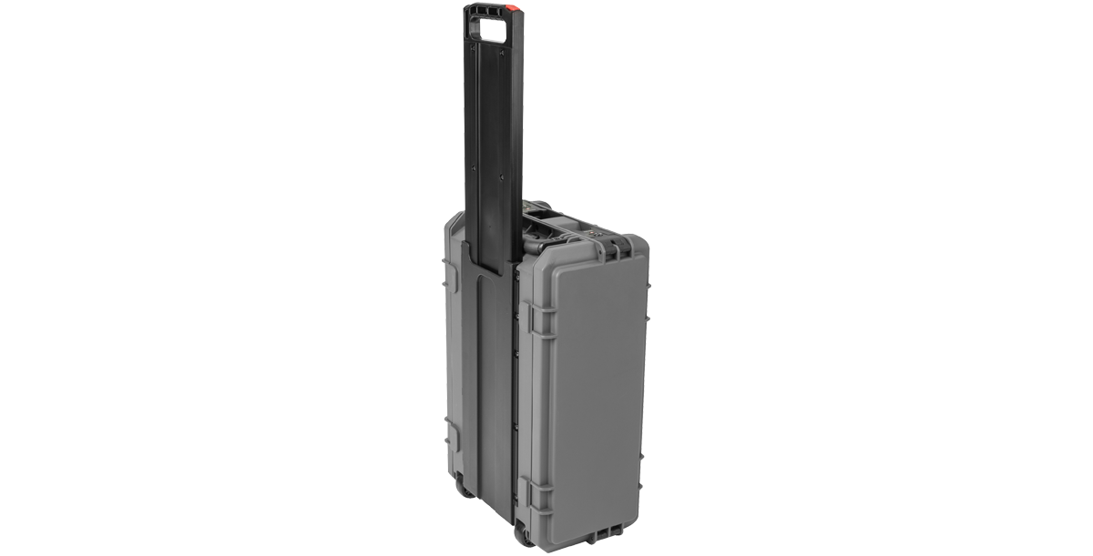 Compact molded rack with extended telescoping handle and wheels, ideal for carry-on travel and secure transport of rack-mounted gear.