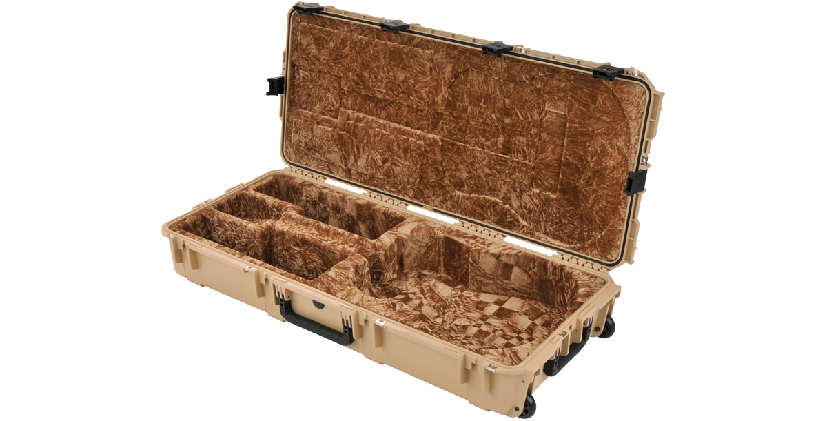 Durable tan SKB waterproof acoustic guitar case open, revealing soft brown interior with molded compartments for secure guitar fit.