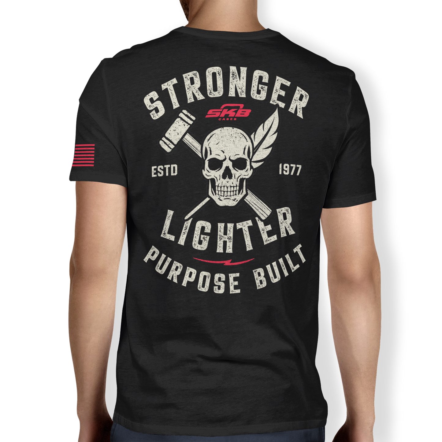 Back view of black performance t-shirt featuring bold skull and crossed tools graphic with 'Stronger Lighter Purpose Built' slogan. Est. 1977 design.