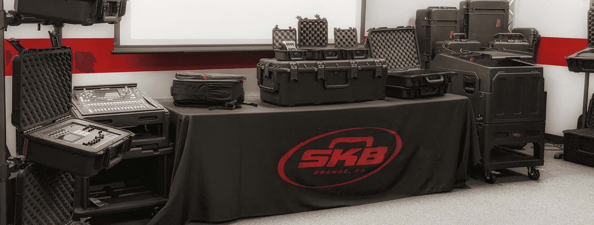 SKB cases displayed on a table with a branded cover in a room setting.