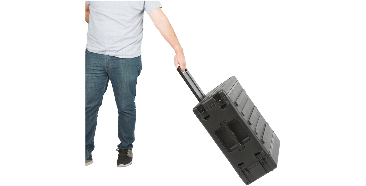 Person pulling the 4U SKB Roto Rolling Rack, demonstrating its ergonomic handle and portable rolling feature for easy mobility.