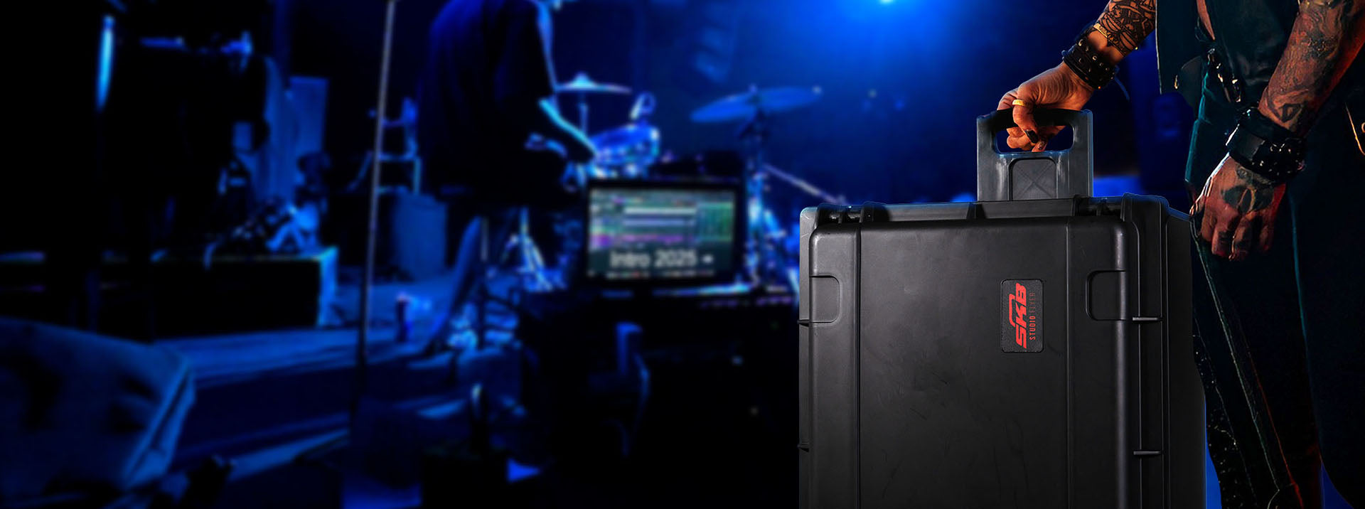 Person holding a large black case with 'Roccat' branding in a dark, possibly gaming or event setting.