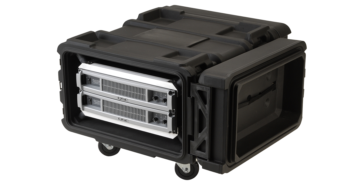 Heavy-duty 24 inch shock rack with QSC amplifiers, roto-molded case and rolling base, designed for pro audio and IT equipment transport.