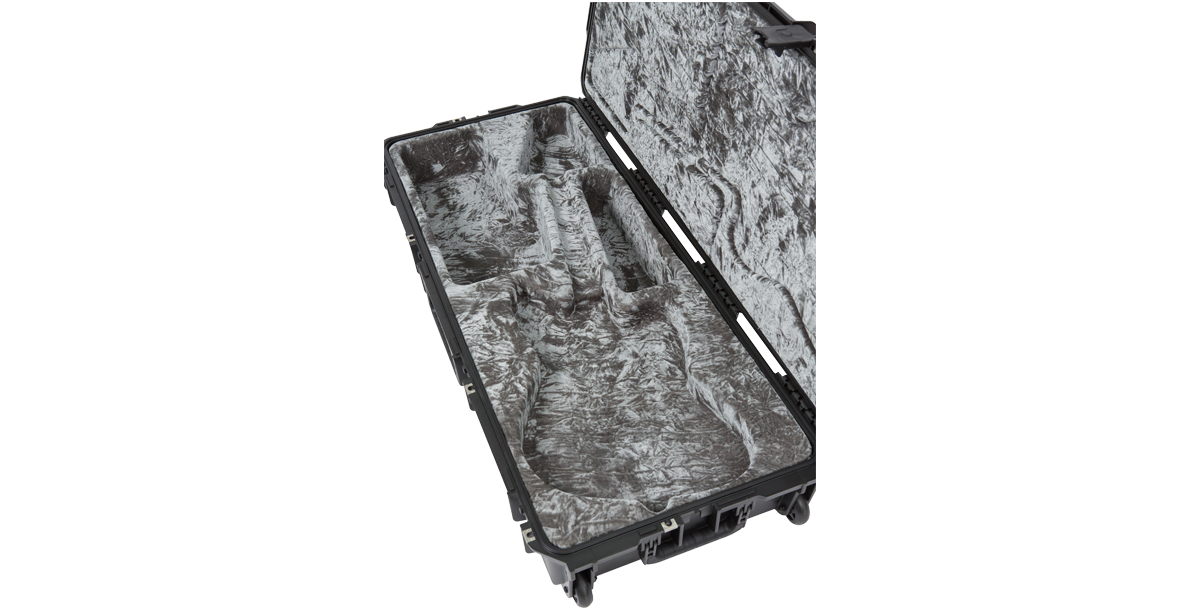 Interior view of empty waterproof guitar case for Jaguar Jazzmaster, showing custom-molded compartments and durable shell.