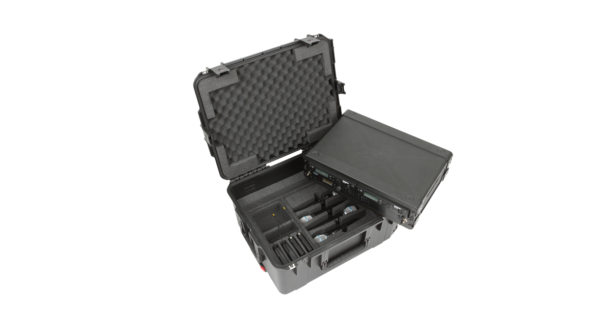 Interior of 2U Wireless Mic Fly Rack case with wireless microphones and transmitters securely stored in foam cutouts.
