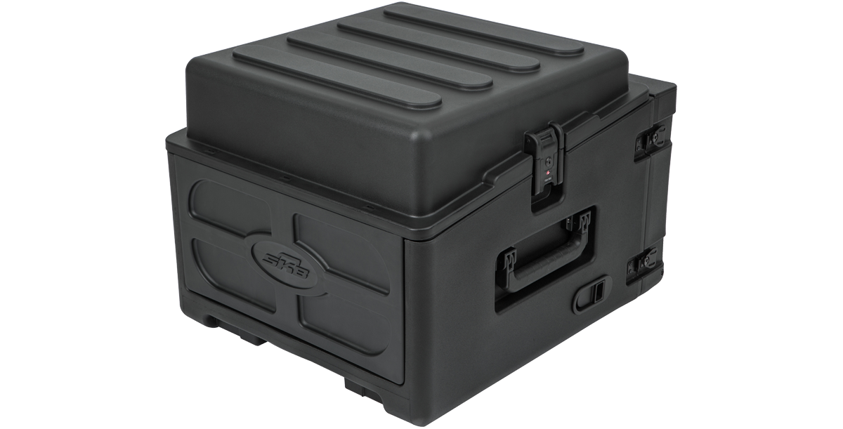 Rolling compact rig with closed lid and side handles. Features TSA-approved latches and rugged design for travel-ready audio transport.