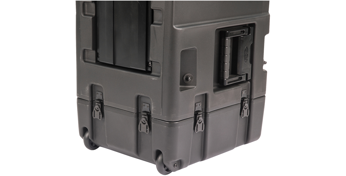 Close-up of 20-inch Shock Rack Case by SKB corner with wheels and latches, designed for mobility and secure closure.