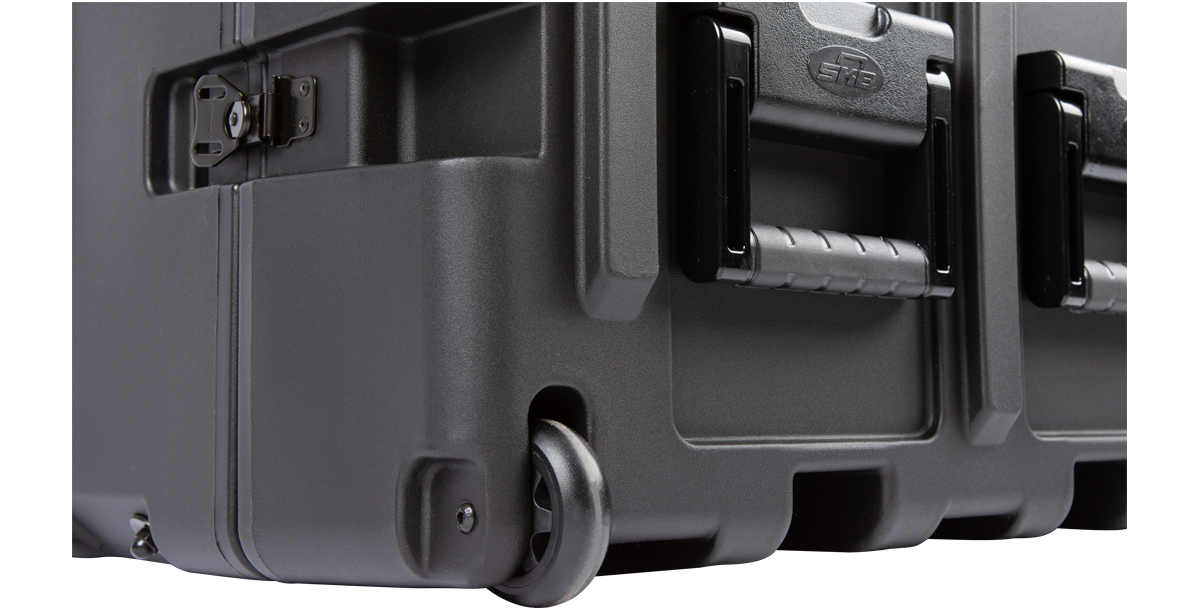 Detail of 14U Shock Rack Transport Case bottom corner featuring built-in wheels and molded carry handles for easy transport.
