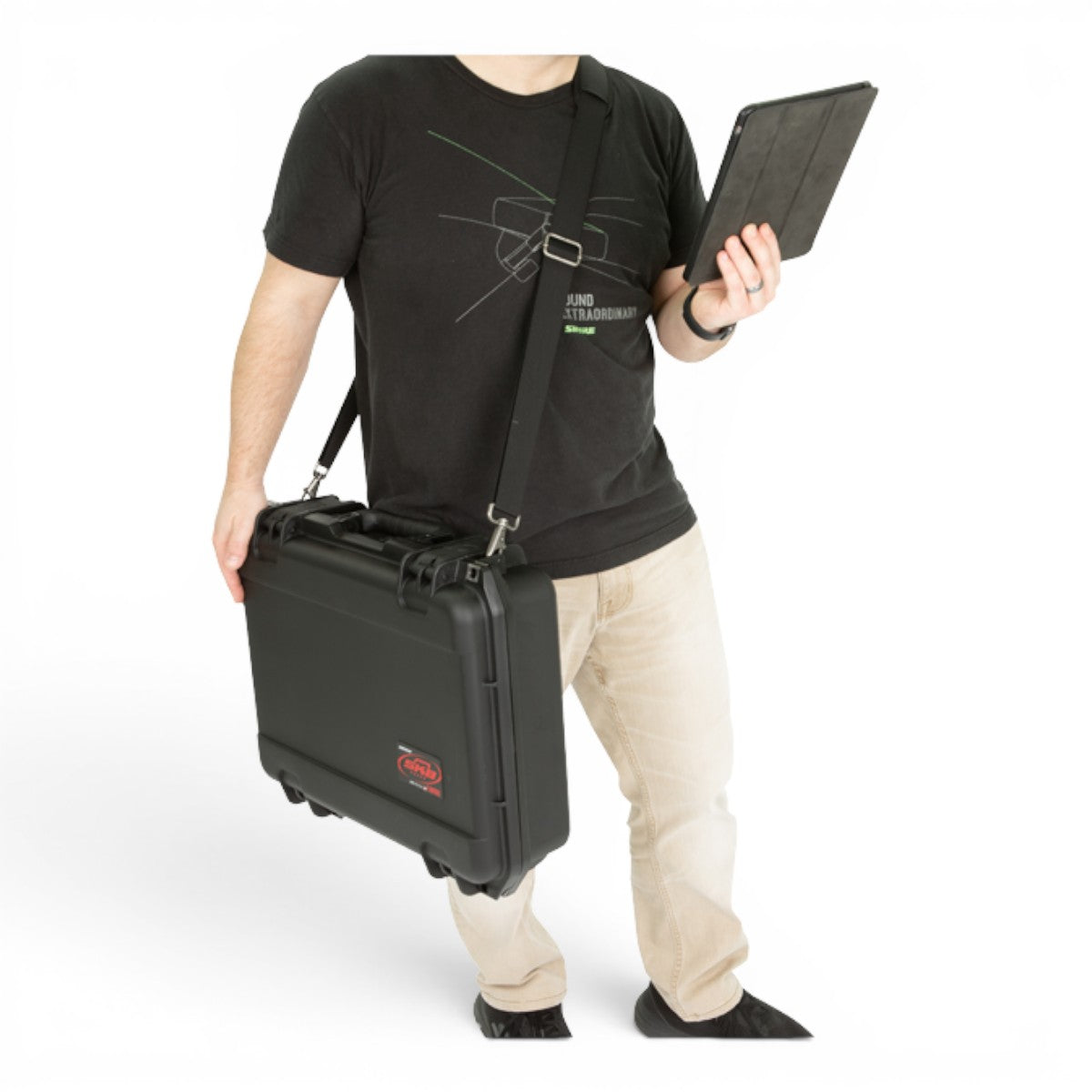 SKB Cases adjustable padded black shoulder strap attached to a hard protective equipment case carried by a man