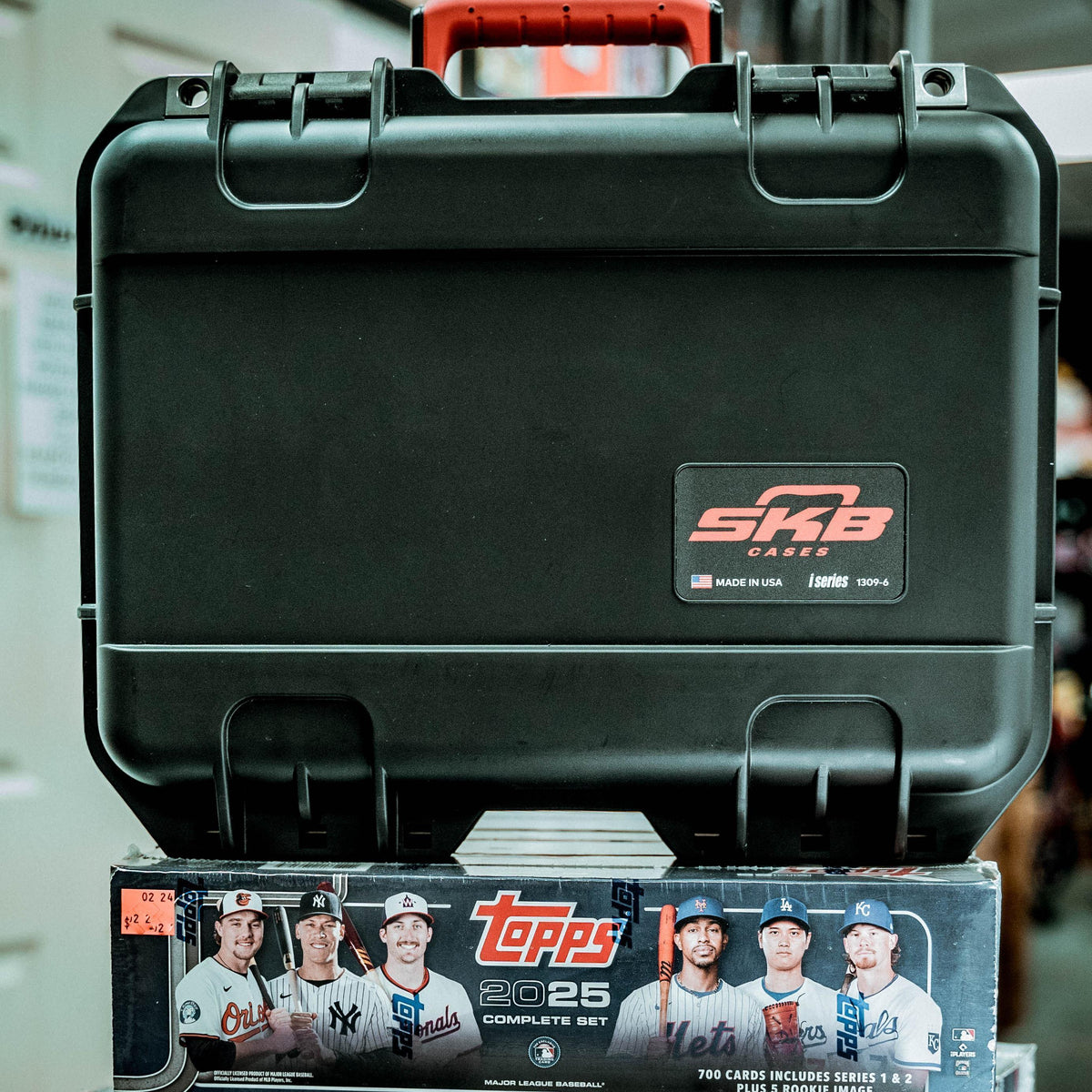 SKB Cases iSeries Slab 90 rugged black waterproof storage case for trading card slabs sitting on a Topps box