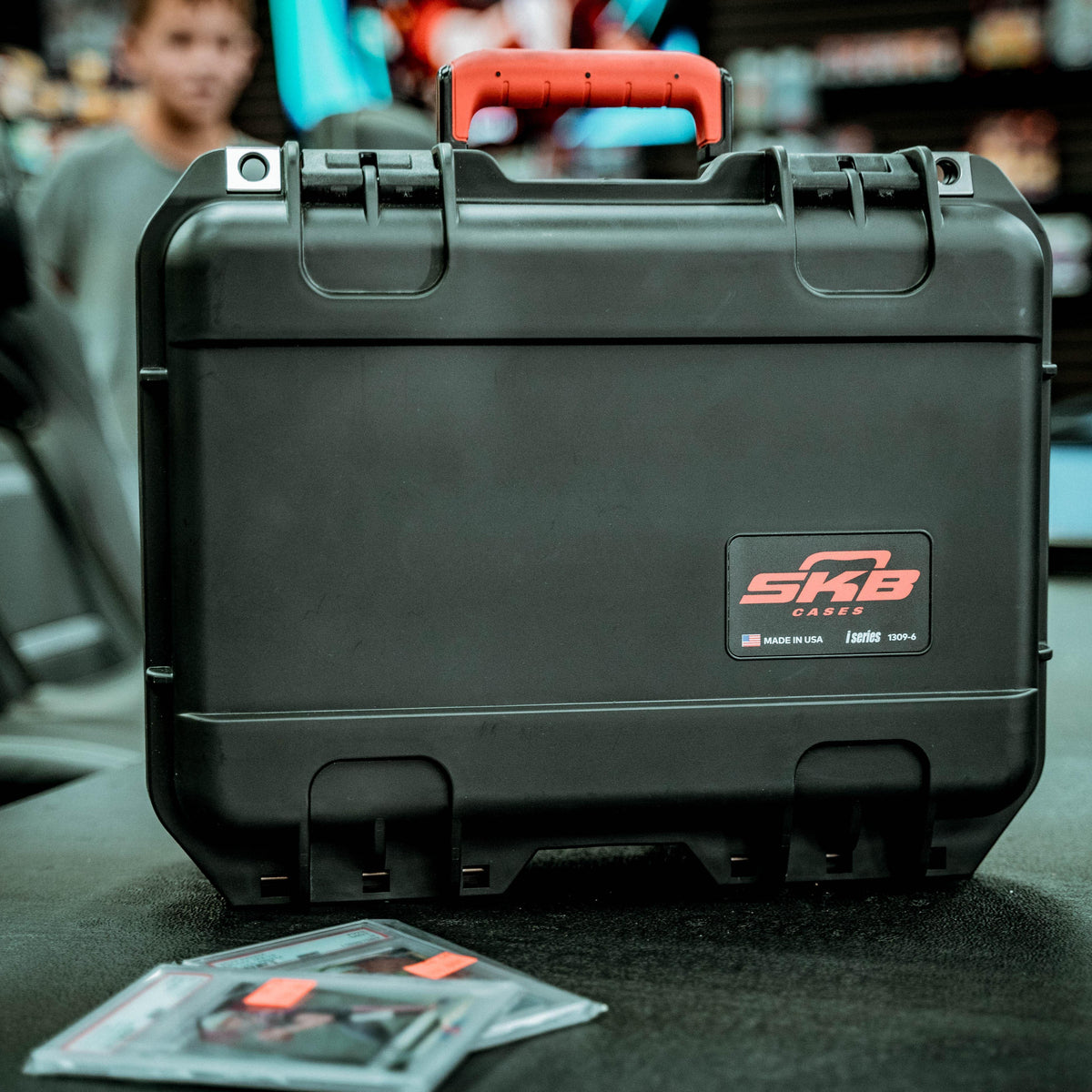 SKB Cases iSeries Slab 90 rugged black waterproof carrying case with a red handle and branding logo.