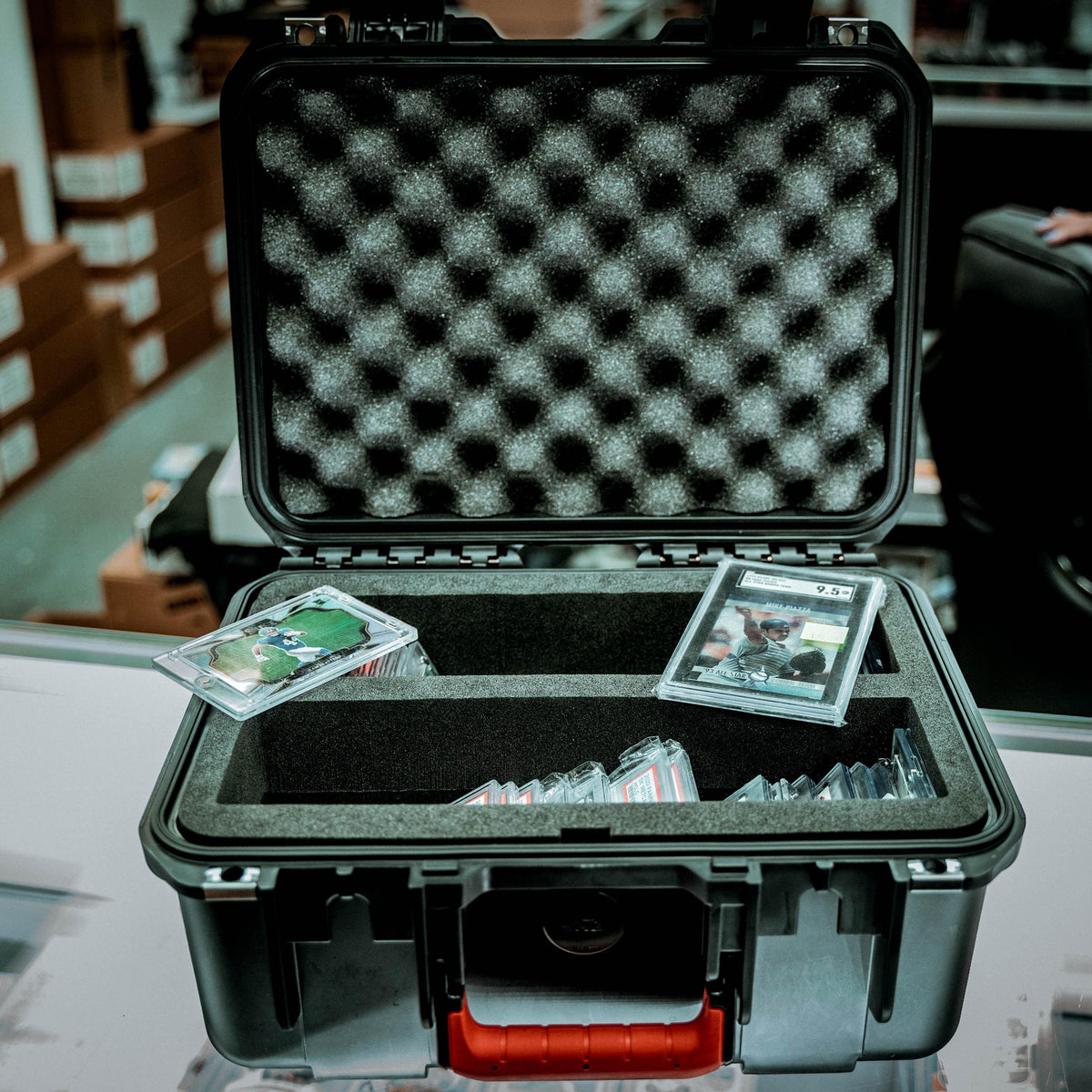 SKB Cases iSeries Slab 90 waterproof hard case with foam interior holding graded sports card slabs in two columns.