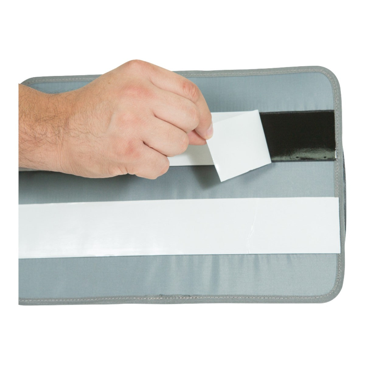 SKB Cases lid organizer back panel with adhesive hook-and-loop strips being peeled for installation in iSeries case