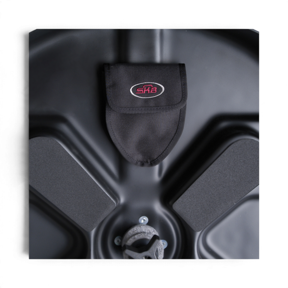 Interior of SKB Cases Roto X Cymbal Vault featuring a black molded polyethylene base, center post, and storage pocket.